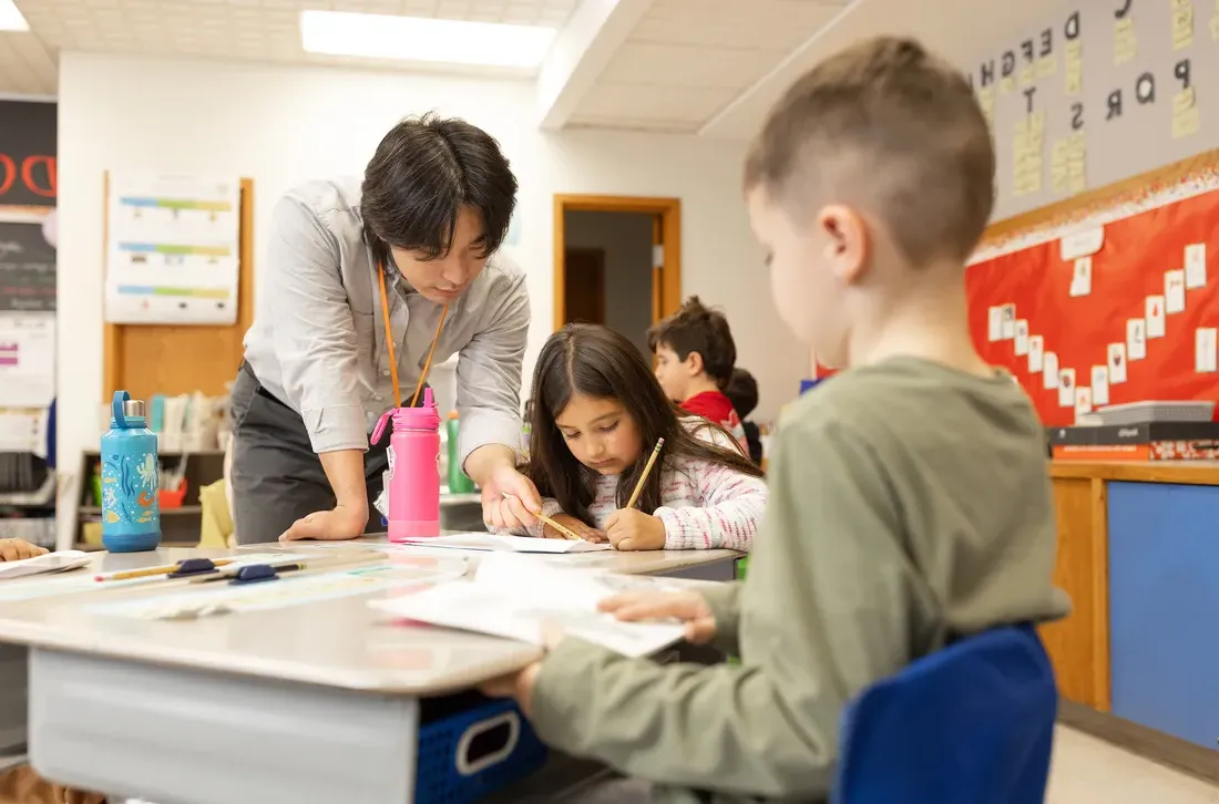 student helping children.